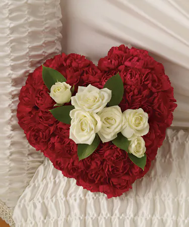 A casket bouquet of white roses enclosed in a 6