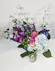 Blue dendrobium orchids paired with blue hydrangea & green hypericum hand-designed in a clear glass vase.
