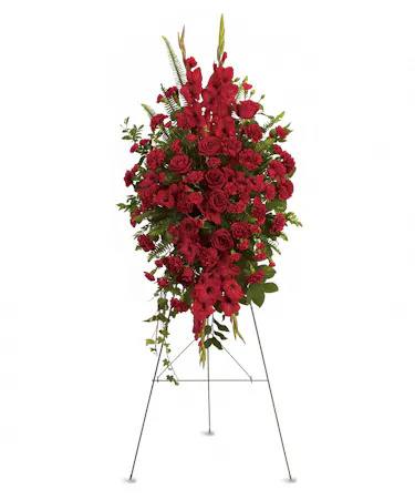 All red standing easel arrangement includes roses, carnations & more accented with greenery