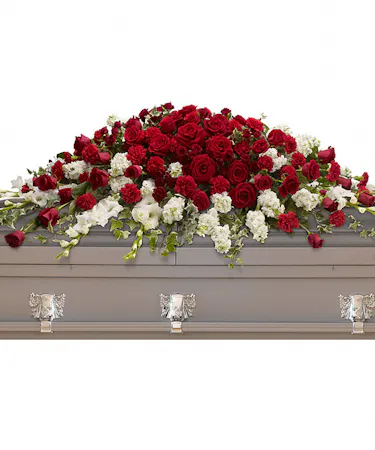 Casket Spray with Red roses, spray roses and carnations with white flowers arranged beautifully with greenery