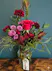 Deep red flowers with textural greenery and a vintage key