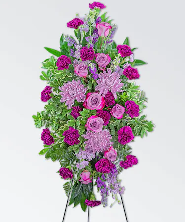 Lavender and pink flowers designed in a standing easel for funeral services