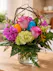 Featuring roses, hydrangea, and festive Easter eggs in awillow-arched vase. 