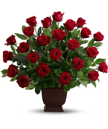 Beautiful red roses and greenery in an urn style container