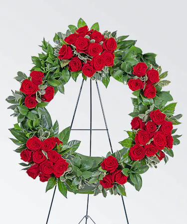 Sympathy wreath with red roses and greenery