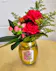 Hot pink carnations, orange spray roses, accent flowers and greenery in a Queen's Jewels embellished wine glass