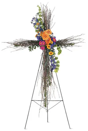 birch cross with a floral spray in bright colors on standing easel