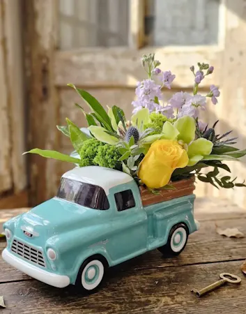 Ceramic 57 chevy truck container with green and yellow flowers