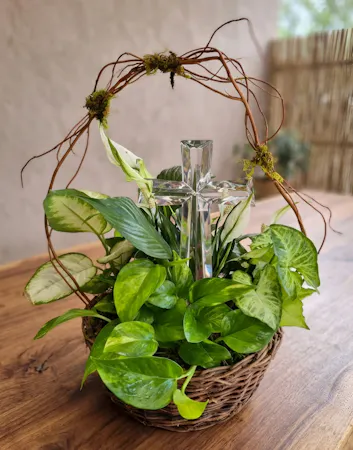 Crystal cross keepsake nestled in a live plant