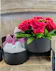 A  double-decker surprise features romantic red roses and carnations on top with luxury bath bombs hidden in the base