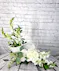 A beautiful all white sympathy bouquet featuring a keepsake ceramic angel wing