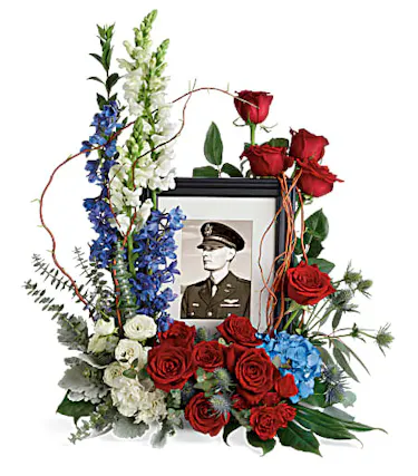 Patriotic flowers surrounding photo frame