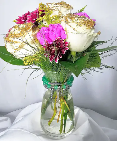This fun arrangement arrives with glittered roses, carnations and daisies in a cute vase which we accent with a set of Soul Stacks Bracelets