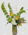 Glittered yellow roses, white hydrangea, green chrysanthemums, bells of Ireland in a vase with gold accents