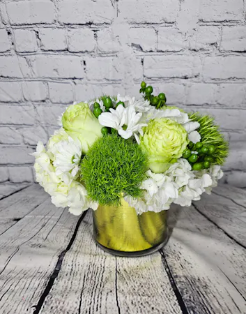 Green roses and green tricks with white hydrangea and daisies in an gold leaf-lined cylinder
