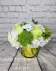 Green roses and green tricks with white hydrangea and daisies in an gold leaf-lined cylinder