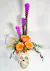 A fabulous ceramic Skull with our special tinted Halloween roses (these vary), purple liatris, yellow solidago and a variety of greenery 