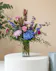Clear vase with blue hydrangea & delphinium, white stock, lavender roses, purple carnations and lush greenery