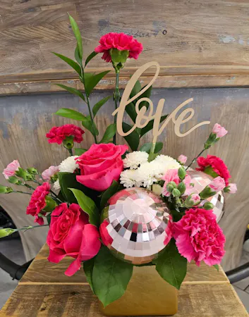 Pink roses, carnations and mini carnations in a gold cube with pink 