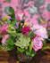 Lavender roses, lavender chrysanthemums, lime green button mums, red hypericum berry, a succulent in a short glass cylinder