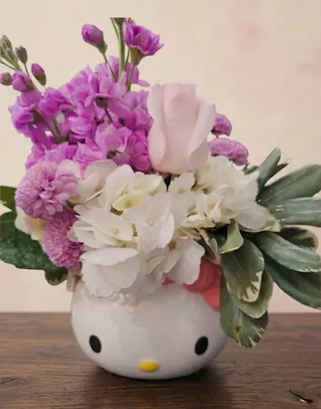 Hello Kitty Friendship Arrangement: featuring pink roses, white hydrangea and lavender stock in a collectible Hello Kitty ceramic vase