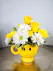 Yellow & White daisies in a smile face mug with yellow roses