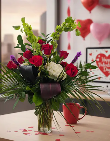 Dozen red roses with hydrangea, bells of Ireland, liatris and lush greenery