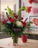 Dozen red roses with hydrangea, bells of Ireland, liatris and lush greenery