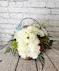  Our Petal Poodle is designed with white carnations in a basket with accent flowers added for color.  